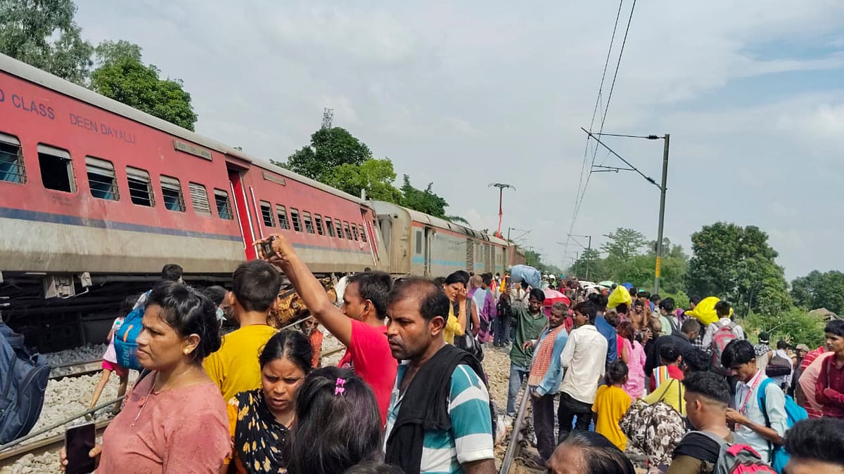 PTI : Passengers and locals near the derailed coaches of the Dibrugarh Express train after an accident, in Gonda district